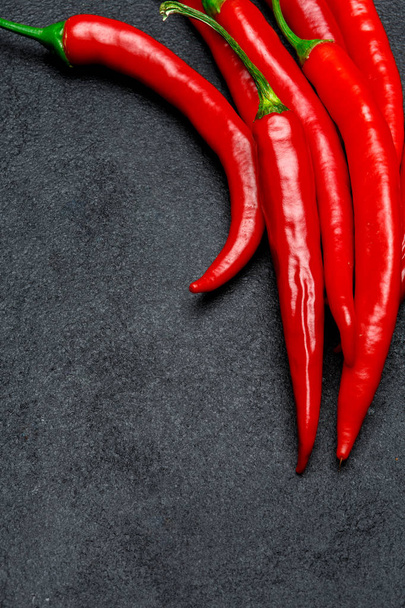 red chili pepper on dark concrete background - Foto, afbeelding