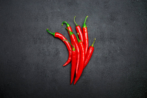 red chili pepper on dark concrete background - Foto, Imagen