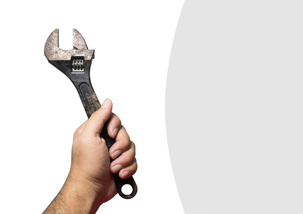 Παλιά ρυθμιζόμενο γαλλικό κλειδί με ένα μαύρο χρώμα στο χέρι του μηχανικός άνθρωπος. - Φωτογραφία, εικόνα