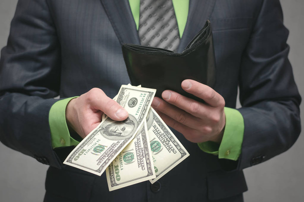 Business man holding in hands dollars money. Give money. Financial help. Bank loan. Business success concept close up background. - Φωτογραφία, εικόνα