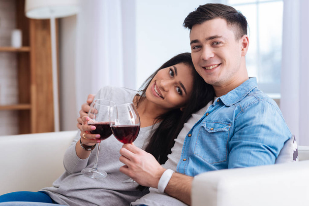 Energetic joyful couple sipping wine - Valokuva, kuva