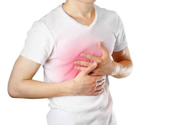 A man holds the Breasts. The pain in his chest. Heartburn. Stoma - Photo, image