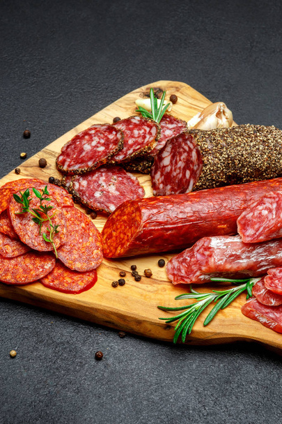 Dried organic salami sausage on wooden cutting board - Photo, Image