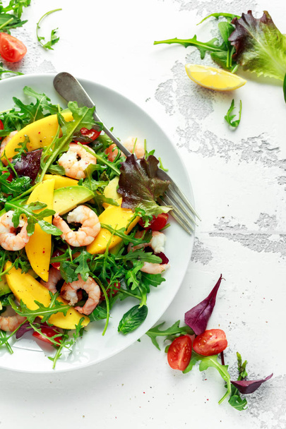 Fresh Avocado, Shrimps, Mango salad with lettuce green mix, cherry tomatoes, herbs and olive oil, lemon dressing. healthy food - Zdjęcie, obraz