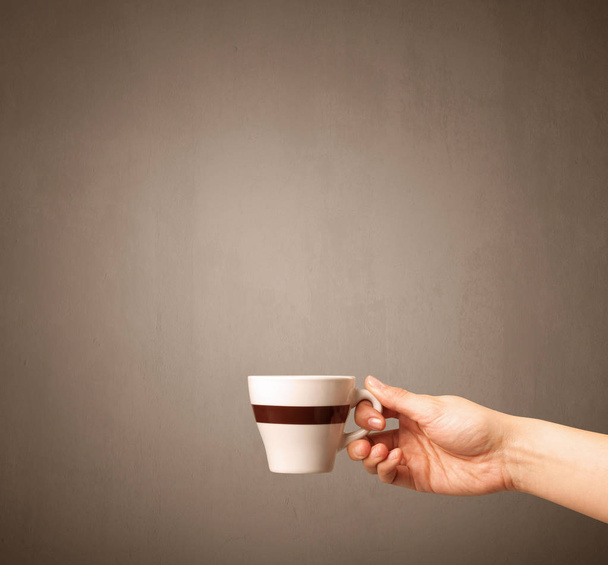 Female hand holding coffee cup - 写真・画像