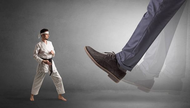Big foot treading small karate man - Foto, Imagem