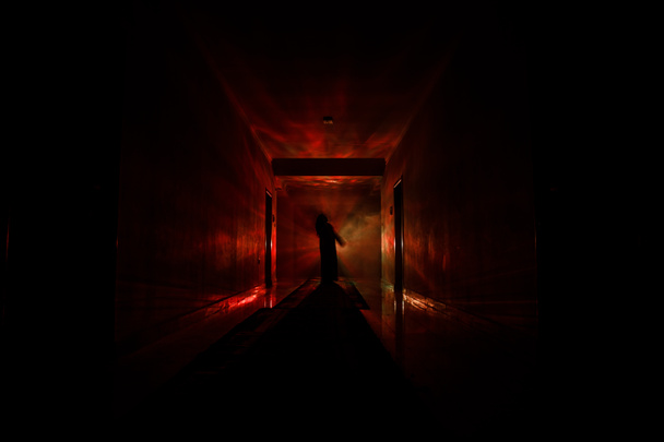 Silhouette raccapricciante nel buio edificio abbandonato. Corridoio scuro con porte armadio e luci con silhouette di persona orrore spettrale in piedi con pose diverse
. - Foto, immagini
