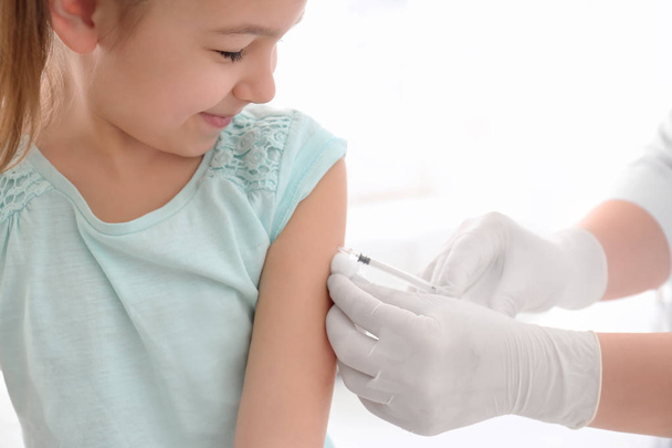 Doctor vaccinating little girl in hospital - Fotó, kép