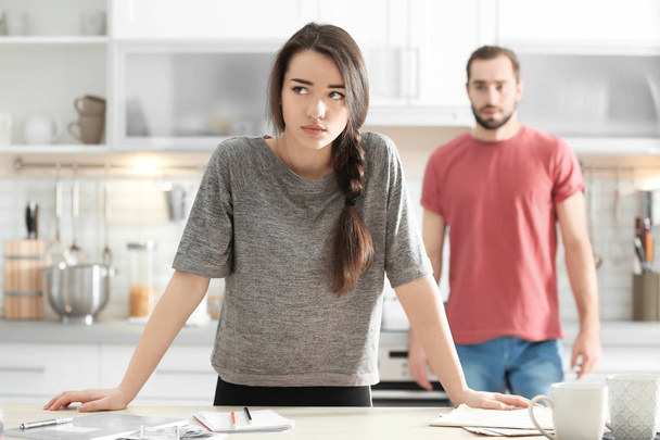 Young couple ignoring each other after having argument in kitchen - Fotó, kép