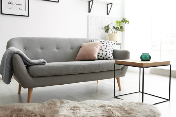 Cozy living room interior with comfortable sofa - Фото, изображение