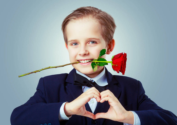 cute boy with a rose - Foto, Bild