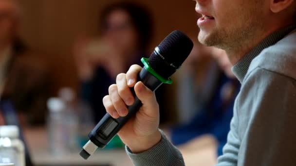 Speaker at conference holding microphone - Materiał filmowy, wideo