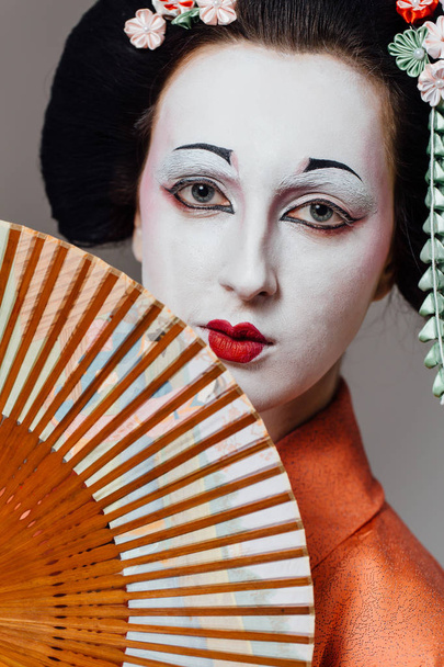 Woman in geisha makeup and a traditional Japanese kimono. Studio, Indoor. - Fotoğraf, Görsel