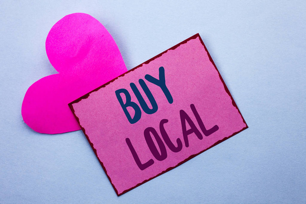 Writing note showing  Buy Local. Business photo showcasing Buying Purchase Locally Shop Store Market Buylocal Retailers written on Pink Sticky Note Paper on the Plain background with Heart. - Photo, Image