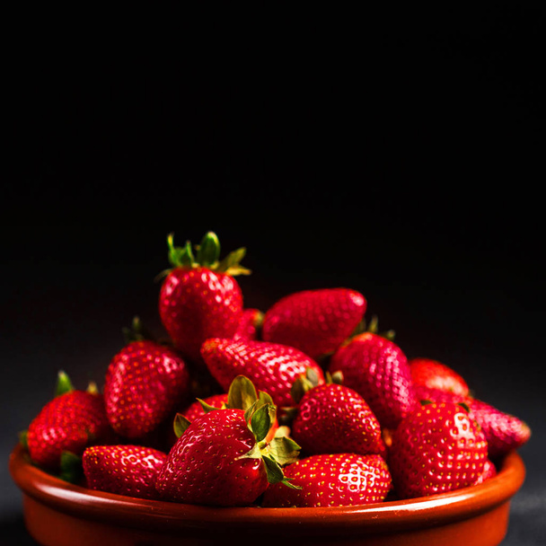 Fresh strawberries on black background  - 写真・画像