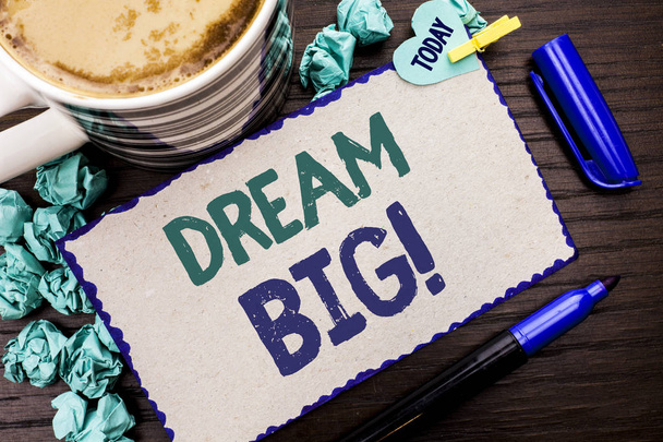 Conceptual hand writing showing Dream Big. Business photo showcasing Motivation Plan Aim Dream Vision Strategy Challenge Idea written Cardboard Piece on wooden background Today Pen Coffee. - Photo, Image