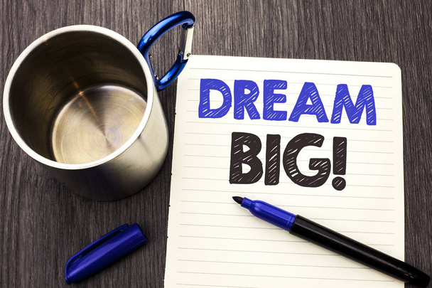 Conceptual hand writing showing Dream Big. Business photo showcasing Motivation Plan Aim Dream Vision Strategy Challenge Idea written on Notebook Paper wooden background Marker and Cup - Photo, Image