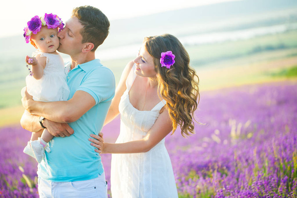 Young family in a lavender field - Φωτογραφία, εικόνα