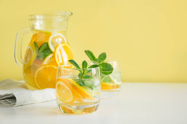 Summer detox lemonade. Water with lemon,orange, ice and mint in glassful. - Fotó, kép