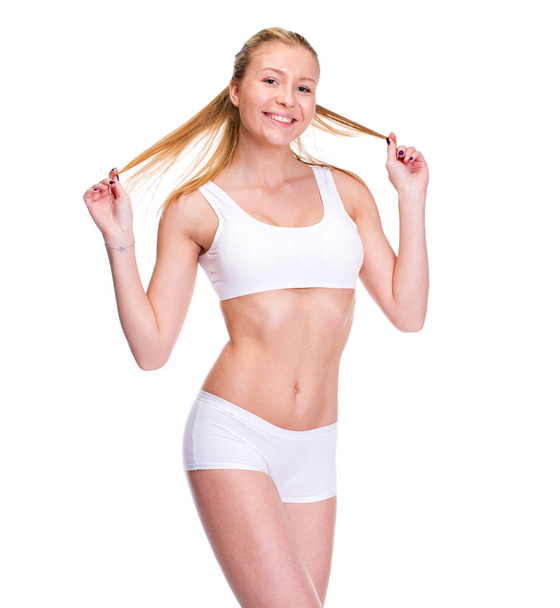 Joven hermosa mujer rubia en ropa de fitness blanca
 - Foto, Imagen