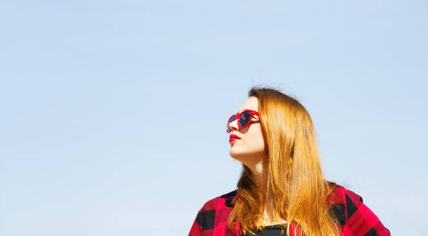 Portrait of a beautiful woman on sunny day wearing stylish sunglasses female enjoying summertime happy summer holidays. - Фото, зображення