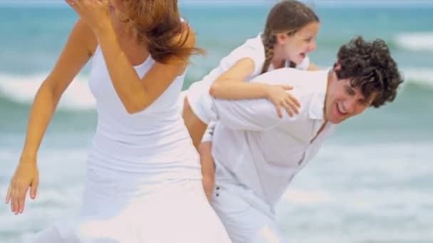 幸せの白人親のビーチの上を歩いて一緒に娘を楽しむ休日 - 映像、動画