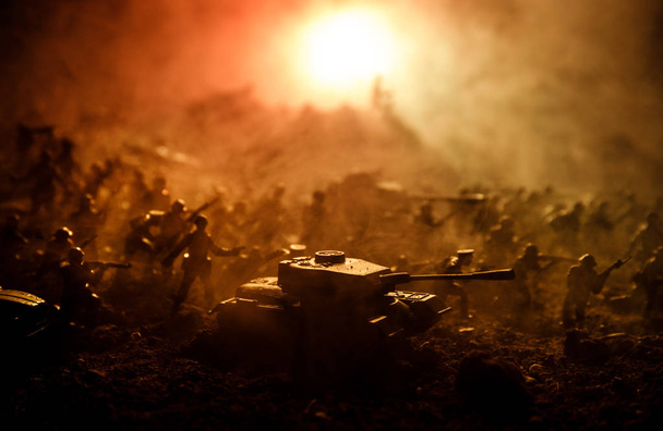 War Concept. Military silhouettes fighting scene on war fog sky background, World War Soldiers Silhouettes Below Cloudy Skyline At night. Attack scene. Selective focus Tanks battle. Decoration - Photo, Image