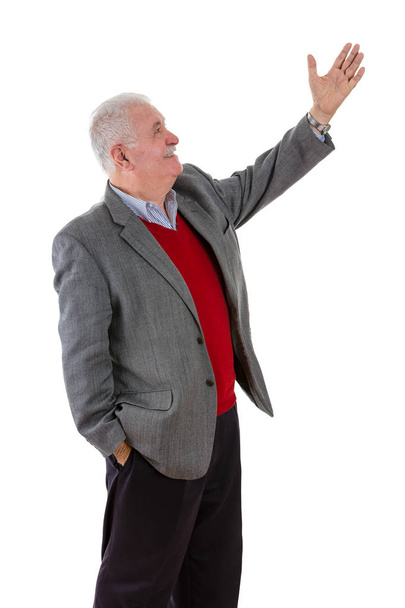 Senior grey-haired man raising his left arm - Foto, Imagen