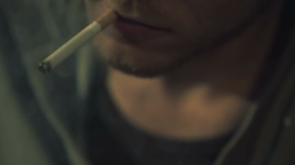 Addicted man smoking cigarette and playing smartphone game closeup, bad habit - Filmati, video