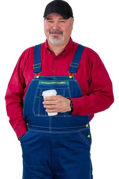 Friendly smiling farm worker holding coffee - 写真・画像