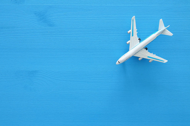 top view photo of toy airplane over blue wooden background. - Valokuva, kuva
