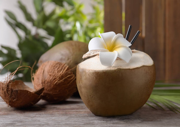 Fresh green coconut on wooden table - Фото, зображення