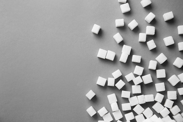 Refined sugar cubes on grey background, top view - Foto, afbeelding