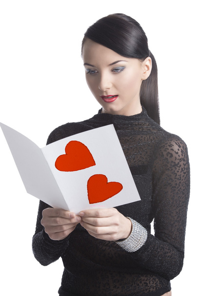 pretty brunette reads valentine postcard - Fotoğraf, Görsel