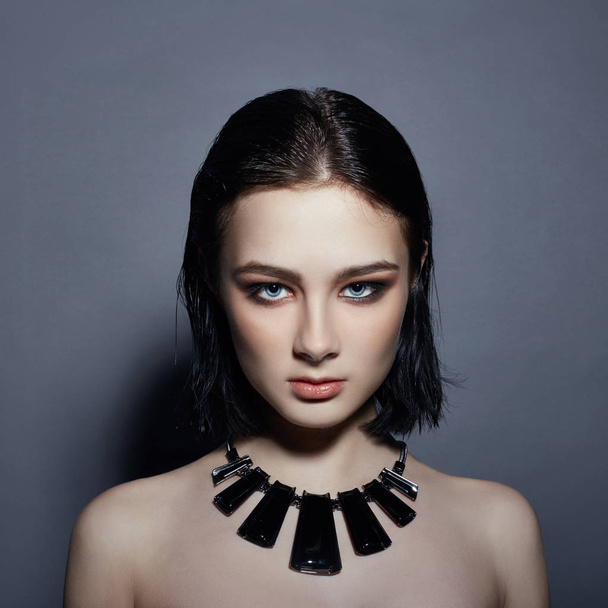 Sexy brunette Girl has black hair jewels around her neck and in  - 写真・画像
