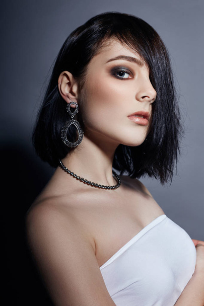 Sexy brunette Girl has black hair jewels around her neck and in  - Фото, зображення