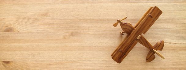 top view photo of toy airplane over wooden background. - Photo, Image