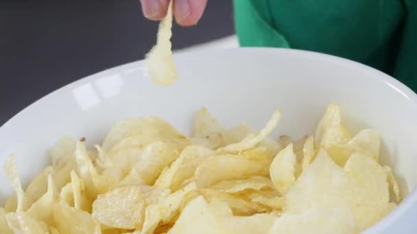 woman eating chips, close up - Materiaali, video
