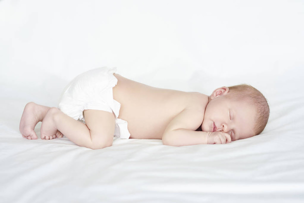 Naked baby sleeping on bed - Photo, Image
