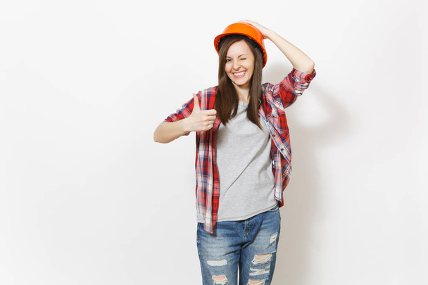 Young smiling beautiful woman in protective construction orange helmet blinking and showing thumb up isolated on white background. Instruments for renovation apartment room. Repair home concept. - Photo, Image