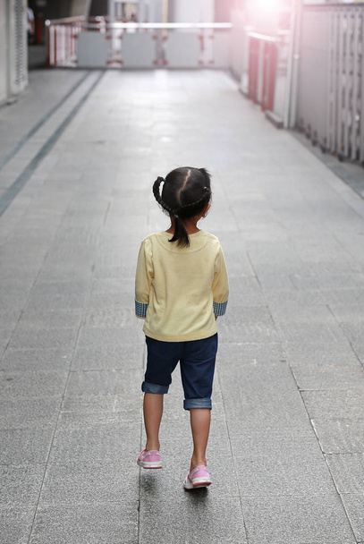 child girl walking alone in sky train station at morning - Foto, Bild