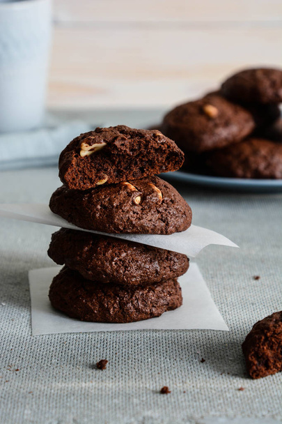 Chocolate cookies for breakfast with hazelnut and a glass of milk on a gray table. - Fotografie, Obrázek