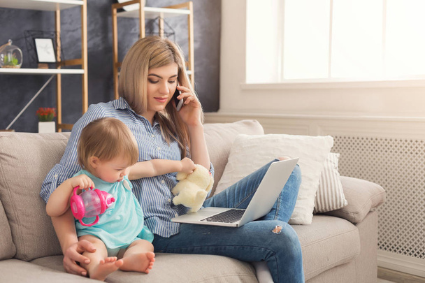 Young mother working and spending time with baby - Photo, Image