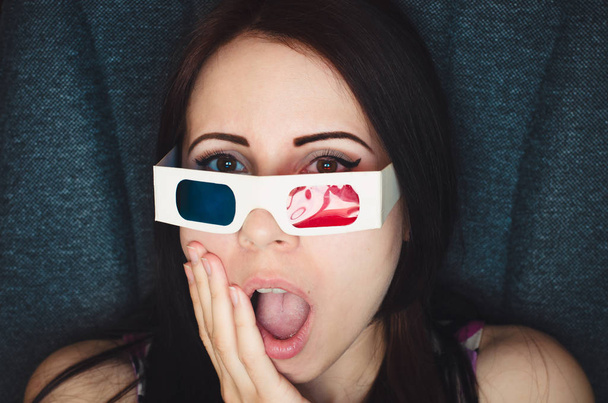 Girl with 3D glasses watches movie with shocked face in cinema - Φωτογραφία, εικόνα
