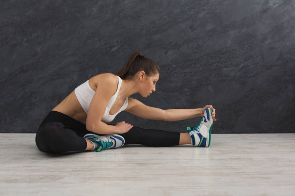 Fitness woman at stretching training indoors - Fotó, kép