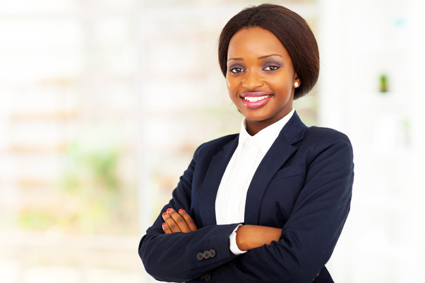 Pretty african american businesswoman half length portrait in office - Fotó, kép