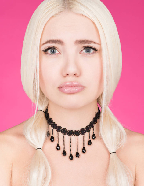 Portrait of a young woman with a pitiful look. Long white hair and makeup - Foto, Imagen