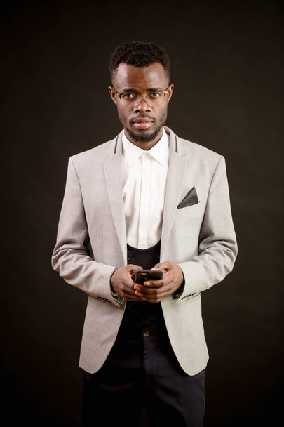 portrait of nice Afro CEO with mobile phone - Fotó, kép