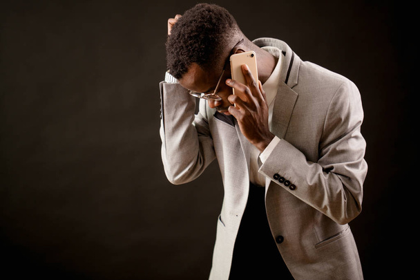 nervous black man trying ringing up to his family - 写真・画像