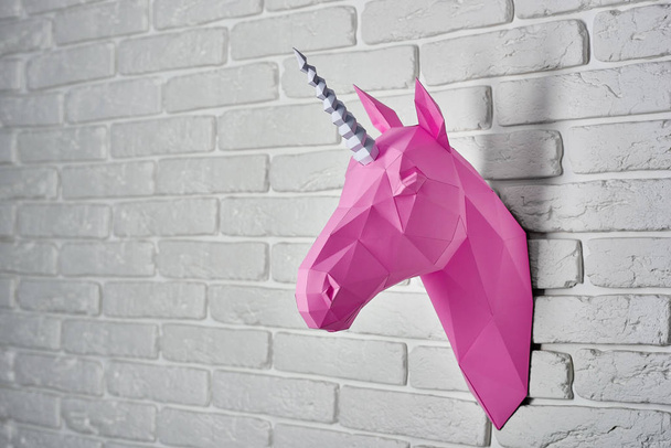 Bright pink unicorn hanging on the wall. - Foto, afbeelding